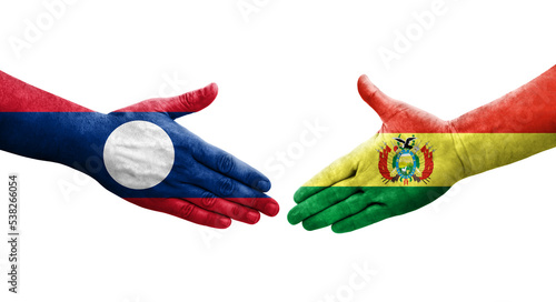 Handshake between Bolivia and Laos flags painted on hands, isolated transparent image.