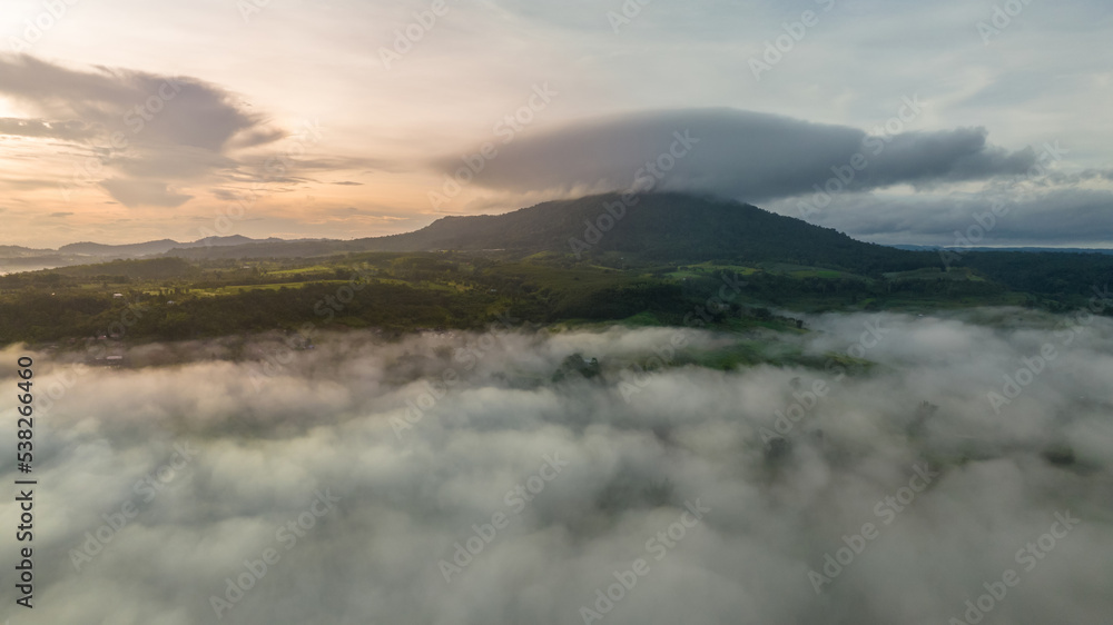 Mountains in fog at beautiful autumn in Phetchabun Thailand. Fog mountain valley, low clouds, forest, colorful sky with. pine trees in spruce foggy forest with bright sunrise Mountains in fog at beautiful autumn in Phetchabun Thailand. Fog mountain valley, low clouds, forest, colorful sky with. pine trees in spruce foggy forest with bright sunrise