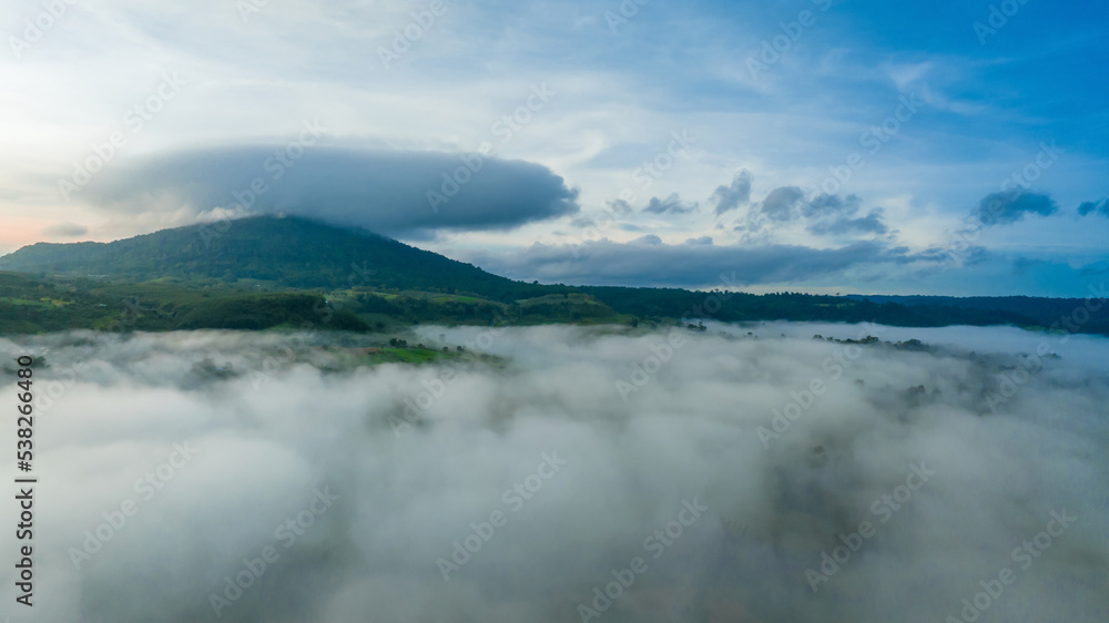 Mountains in fog at beautiful autumn in Phetchabun Thailand. Fog mountain valley, low clouds, forest, colorful sky with.  pine trees in spruce foggy forest with bright sunrise