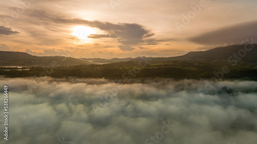 Mountains in fog at beautiful autumn in Phetchabun Thailand. Fog mountain valley  low clouds  forest  colorful sky with.  pine trees in spruce foggy forest with bright sunrise