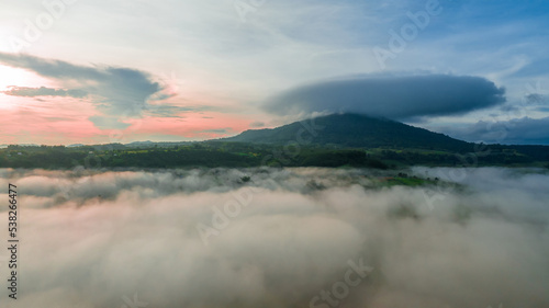 Mountains in fog at beautiful autumn in Phetchabun Thailand. Fog mountain valley, low clouds, forest, colorful sky with. pine trees in spruce foggy forest with bright sunrise