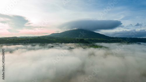 Mountains in fog at beautiful autumn in Phetchabun Thailand. Fog mountain valley, low clouds, forest, colorful sky with. pine trees in spruce foggy forest with bright sunrise