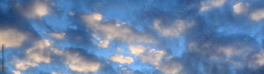 Dark and glowing red clouds clouds in the blue sky at sunrise.Dark red cloudy landscape. The beauty of nature, panorama Dark and glowing red clouds clouds in the blue sky at sunrise.Dark red cloudy landscape. The beauty of nature, panorama