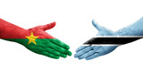 Handshake between Botswana and Burkina Faso flags painted on hands, isolated transparent image.