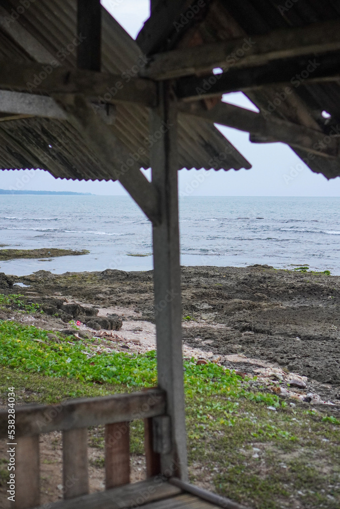 Shot of the sea view on a cloudy day from under the roof of a hut at anyer beach, indonesia