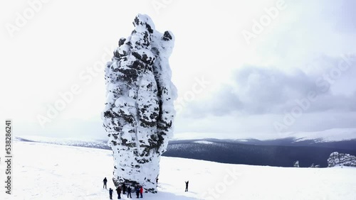 A group of tourists on Man-Pupuner, or Pillars of weathering (Mansi blockheads) - a geological monument, on the territory of the Pechoro-Ilychsky reserve on Mount Man-Pupu-ner 
