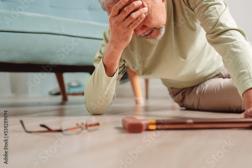 Asian senior man falling on the ground with walker in living room at home. Elderly older mature male having an accident headache for emergency help support from hospital. Insurance health care.