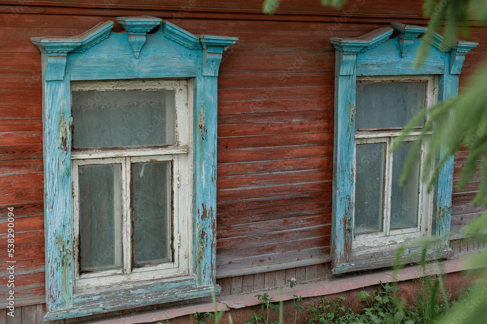 The beautiful old windows with beautifully designed platbands window on an old wooden house in the city of Tula. The beautiful old windows with beautifully designed platbands window on an old wooden house in the city of Tula.