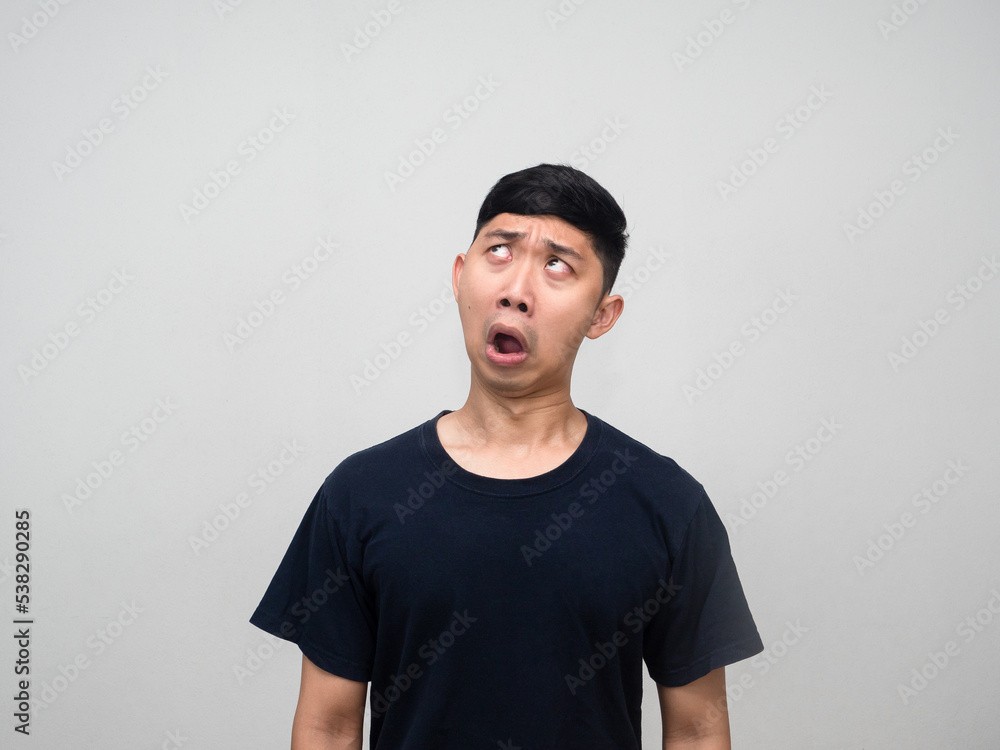 Young asian man feels confused looking up isolated Young asian man feels confused looking up isolated