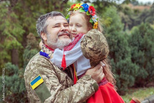 Strong hugs of a Ukrainian soldier with his little daughter.
