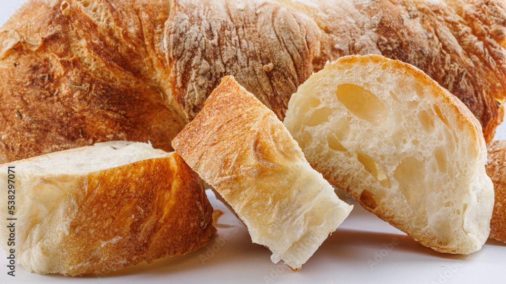 Sliced baguette on a white background. Fresh baguette. Sliced baguette on a white background. Fresh baguette.
