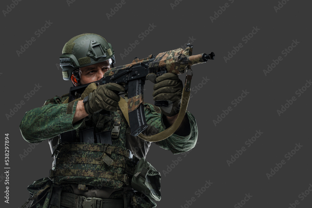 Portrait of military russian man with rifle dressed in modern camouflage uniform. Portrait of military russian man with rifle dressed in modern camouflage uniform.