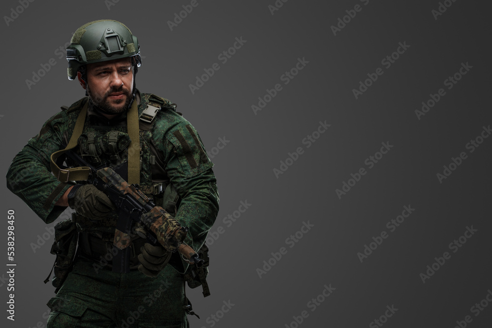 Portrait of military russian man with rifle dressed in modern camouflage uniform. Portrait of military russian man with rifle dressed in modern camouflage uniform.