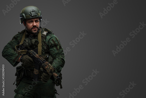 Obraz na plátne Portrait of military russian man with rifle dressed in modern camouflage uniform
