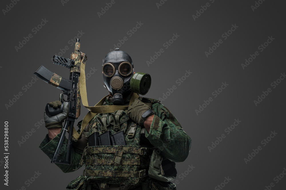 Studio shot of russian soldier dressed in protective uniform and gas mask against gray background. Studio shot of russian soldier dressed in protective uniform and gas mask against gray background.