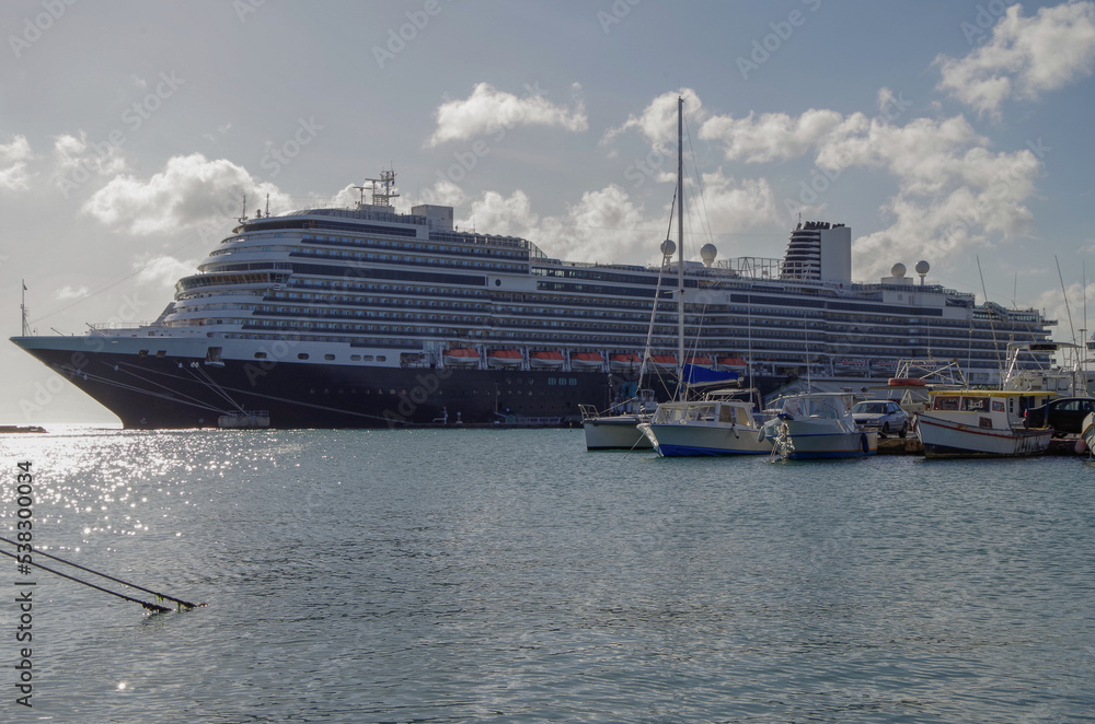 Huge modern HAL cruiseship or cruise ship liner Koningsdam in port during Caribbean cruising dream vacation tropical island scenery