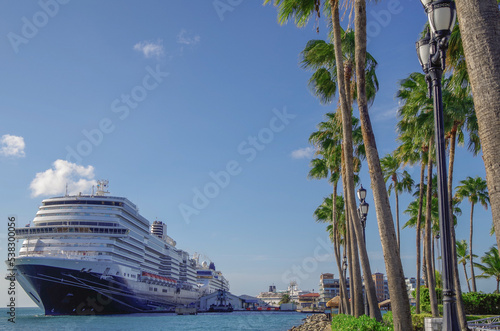 Huge modern HAL cruiseship or cruise ship liner Koningsdam in port during Caribbean cruising dream vacation tropical island scenery photo