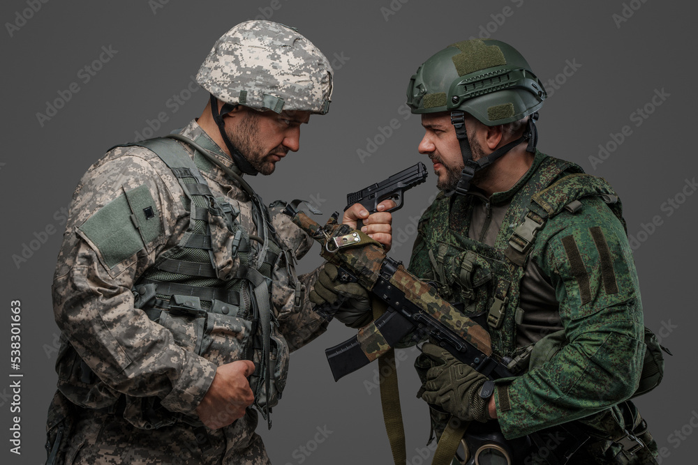 Studio shot of disagreements soldiers dressed in camouflage uniforms.