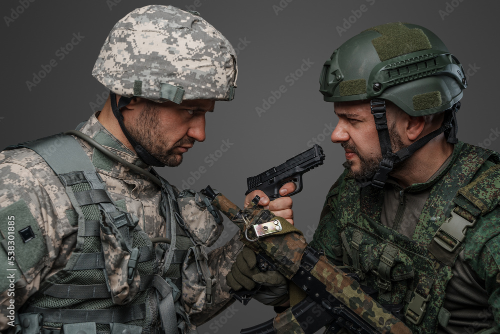Studio shot of disagreements of soldiers dressed in camouflage uniforms. Studio shot of disagreements of soldiers dressed in camouflage uniforms.