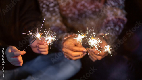 Celebrating in Christmas and New Year festival, Festive burning sparkler with sparks in hands, Enjoy playing with small sparkler hand fireworks.