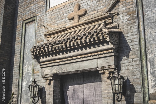 Photography Stone cross over the gate of Mofan Bookstore the former site of the Chinese Angl