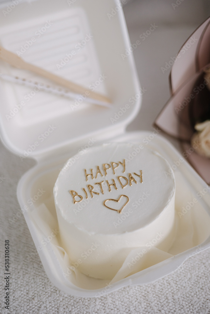Fototapeta premium Bento cake decorated by golden inscription Happy Birthday. Cakes for one person
