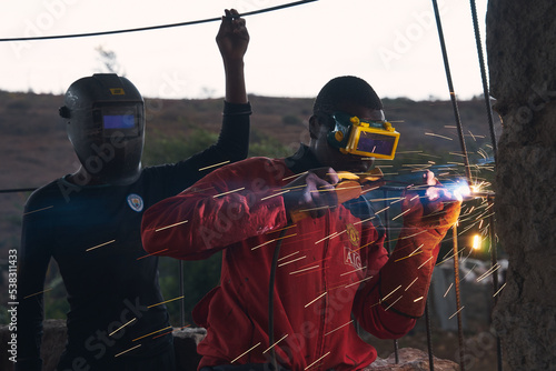 Young black man is welding steel in africa. photo