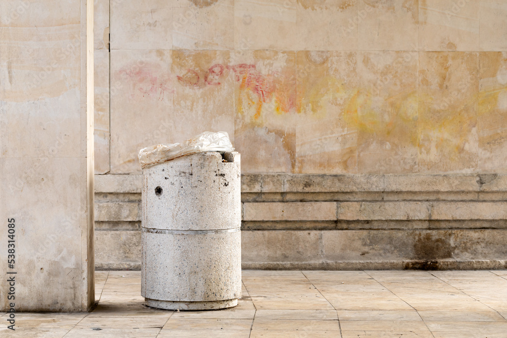 Concrete bin in front of the stone wall. Concrete bin in front of the stone wall.