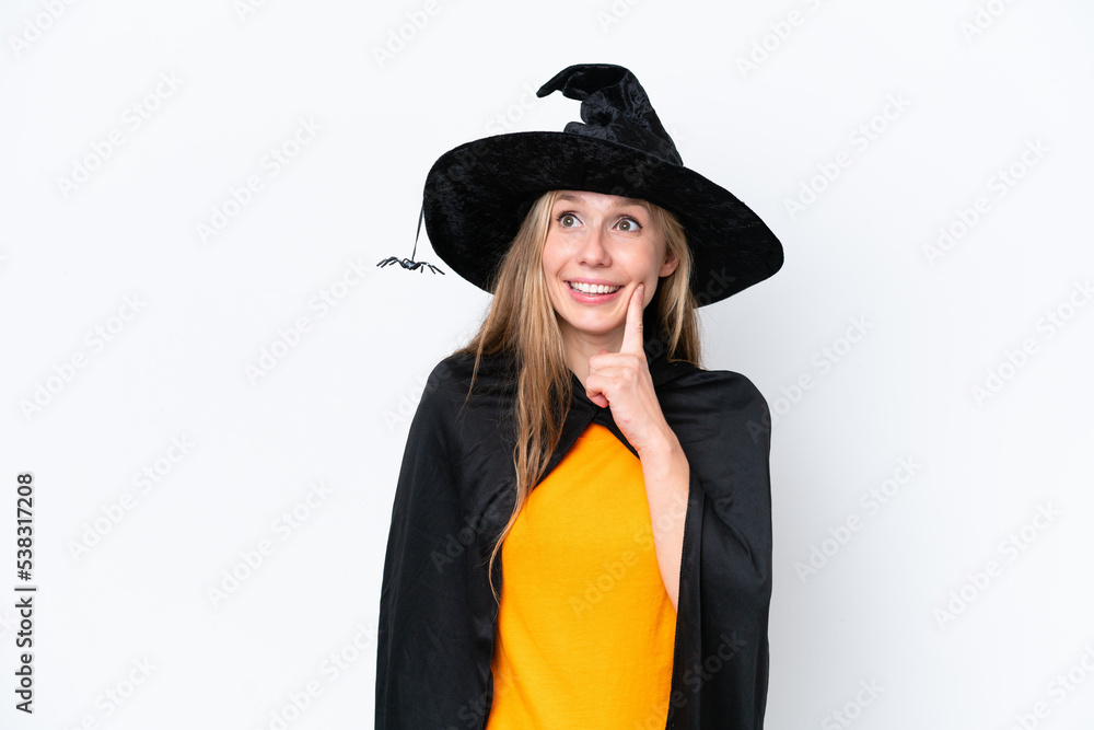 Young blonde woman dressed as a witch isolated on white background thinking an idea while looking up Young blonde woman dressed as a witch isolated on white background thinking an idea while looking up