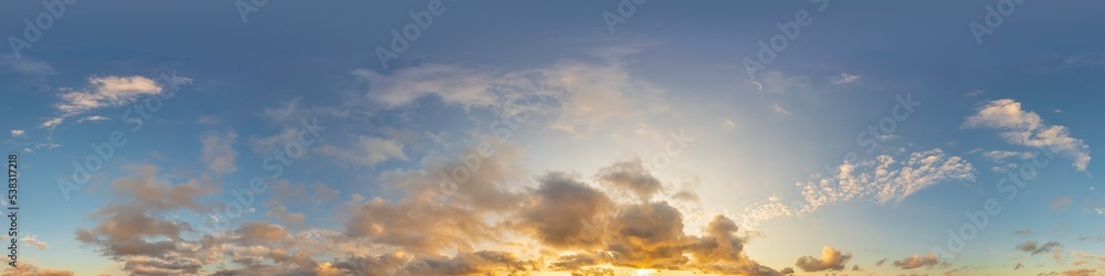 Dark blue sunset sky panorama with golden Cumulus clouds. Seamle
