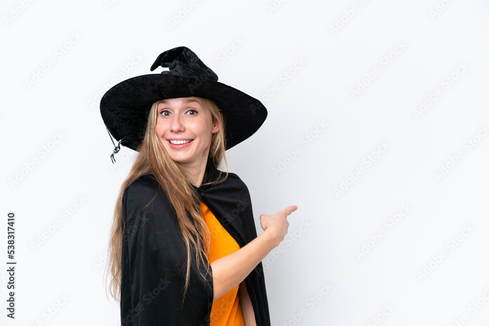 Young blonde woman dressed as a witch isolated on white background pointing back Young blonde woman dressed as a witch isolated on white background pointing back