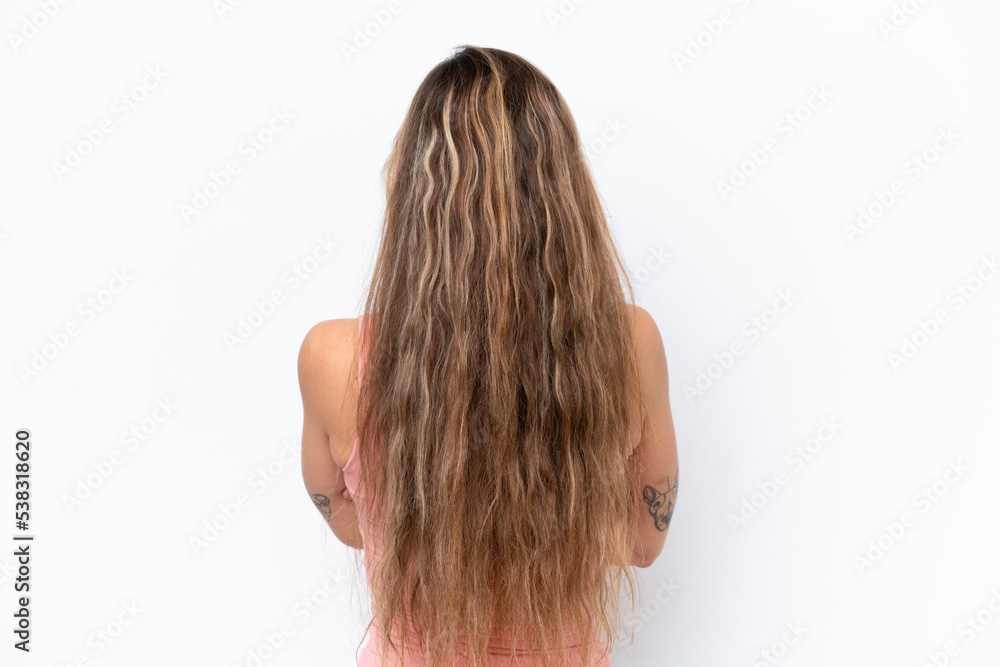 Young caucasian woman isolated on white background in back position Young caucasian woman isolated on white background in back position