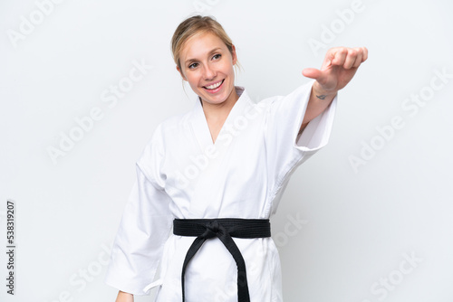 Young caucasian woman doing karate isolated on white background giving a thumbs up gesture
