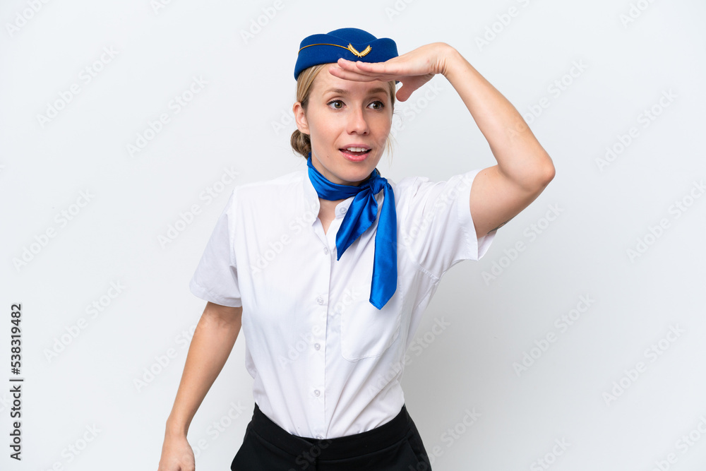 Airplane blonde stewardess woman isolated on white background looking far away with hand to look something Airplane blonde stewardess woman isolated on white background looking far away with hand to look something