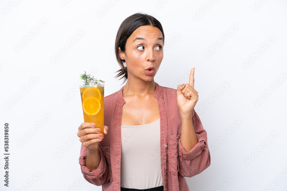 Young hispanic woman holding a cocktail isolated on white background thinking an idea pointing the finger up Young hispanic woman holding a cocktail isolated on white background thinking an idea pointing the finger up