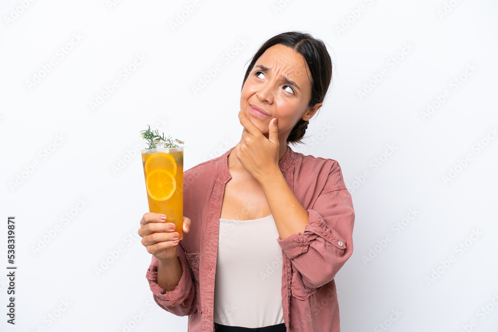 Young hispanic woman holding a cocktail isolated on white background having doubts Young hispanic woman holding a cocktail isolated on white background having doubts