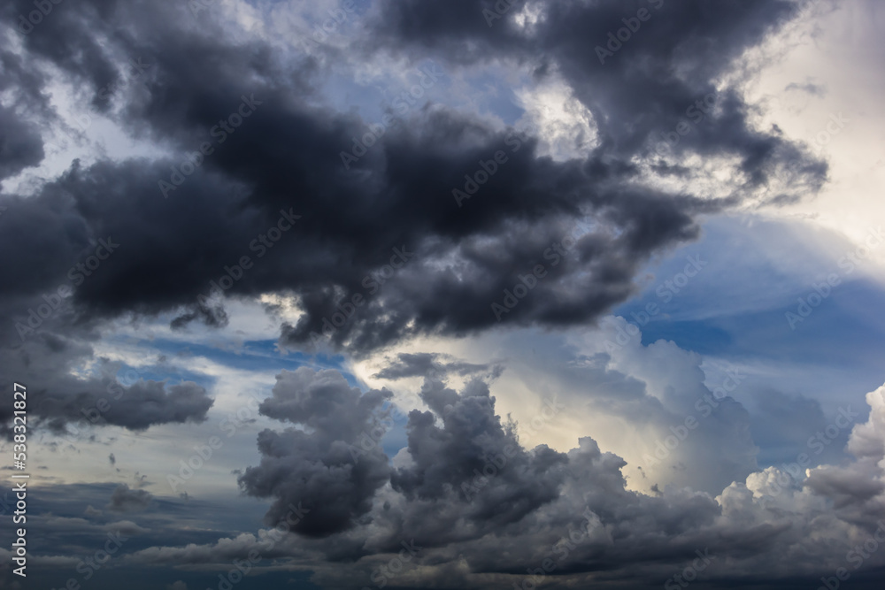 Fototapeta premium The dark sky with heavy clouds converging and a violent storm before the rain.Bad or moody weather sky and environment. carbon dioxide emissions, greenhouse effect, global warming, climate change.