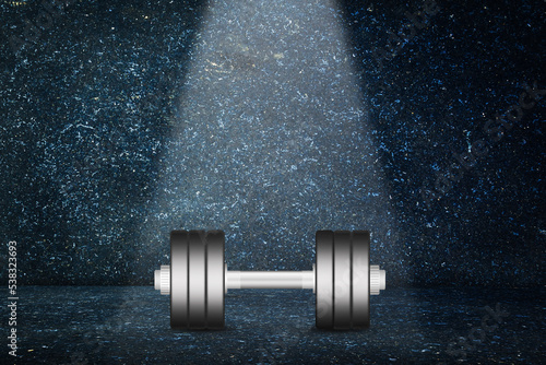 Dumbbells on a dark background. Beam of light from above. The concept of sports strength. Sports equipment, gym, fitness. Sports