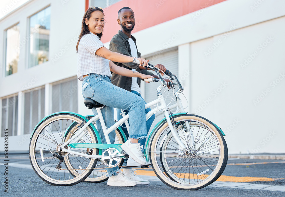 Happy couple, bicycle and city street travel for exercise, fun or adventure outdoor. Black and asian tourist man and woman cycling for carbon footprint on bike in urban town traveling in South Africa Happy couple, bicycle and city street travel for exercise, fun or adventure outdoor. Black and asian tourist man and woman cycling for carbon footprint on bike in urban town traveling in South Africa