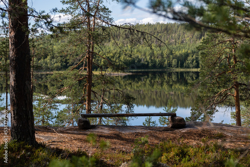 Wooden plank placed on top of rocks as a makeshift bench next to a lake in Repovesi National Park, Kouvola, Finland