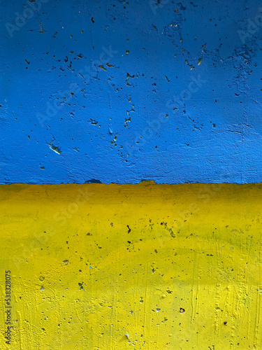 Wall is painted blue and yellow. Ukrainian flag background