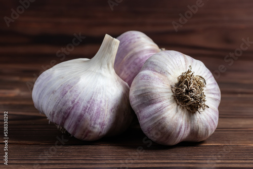 Garlic bulb on wooden background close up