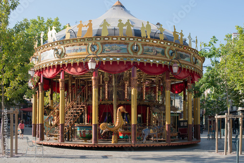 Traditional merry-go-round with wooden animals.