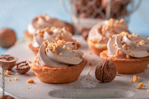 Homemade mini tartlets with vanilla cream and nuts.