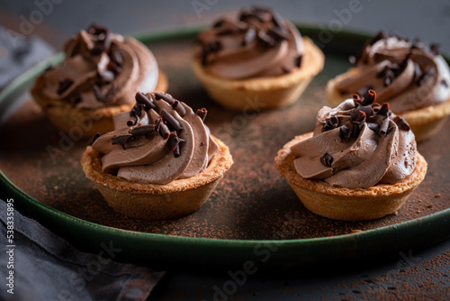 Konstfotografi Delicious mini tartlets as a small brown snack.