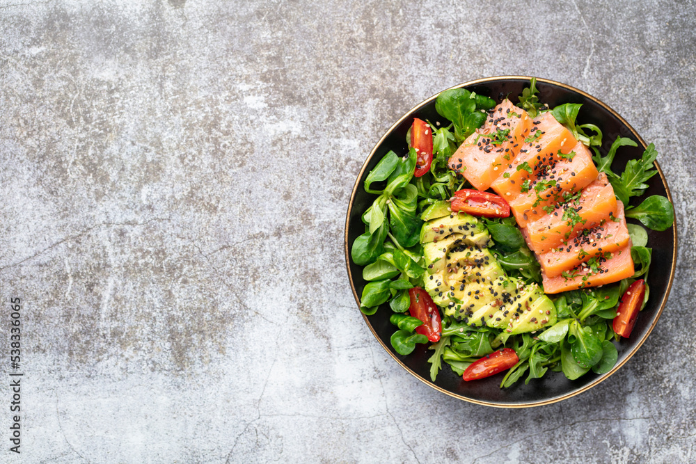 Salmon fish fillet with fresh salad, avocado top view. Salmon fish fillet with fresh salad, avocado top view.