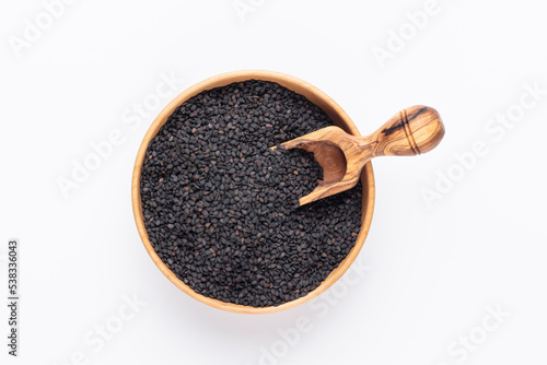 Bio natural black sesame seeds on wooden bowl.