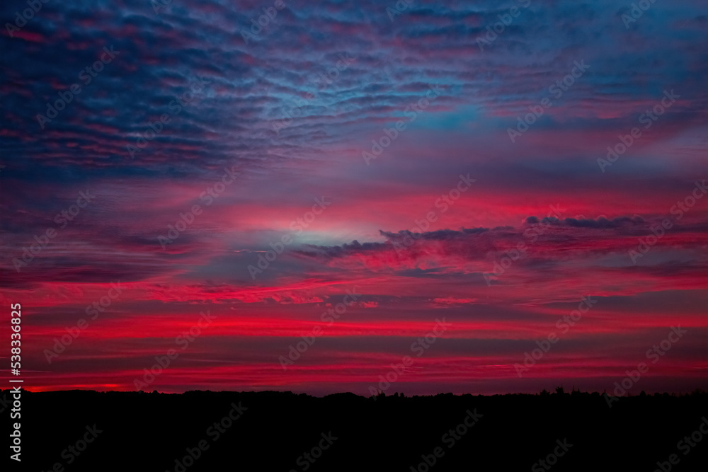 Beautiful sky background with clouds after sunset. Red sky