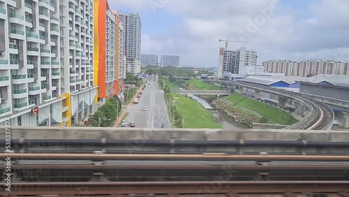 Outside view of buildings and road from the train photo