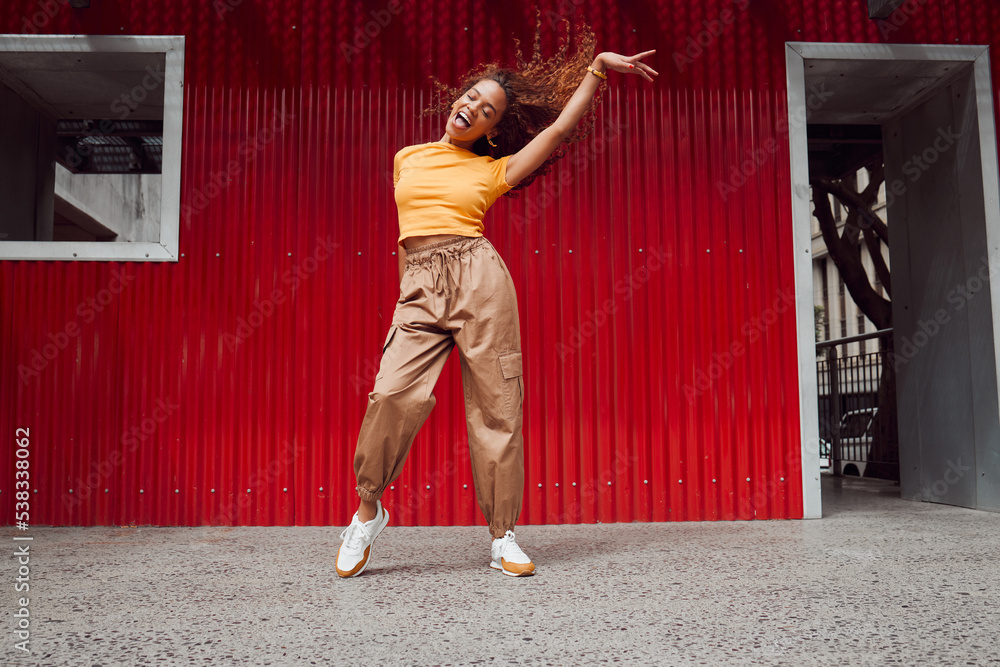 Dance, freedom and fun with a black woman on a red background, dancing or happy with a smile while moving to music. Dancer, free and expression with an attractive young female in rhythmic movement - obrazy, fototapety, plakaty 